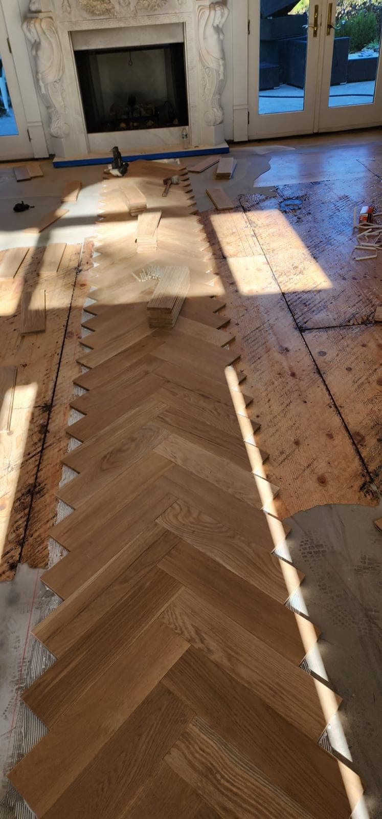 Herringbone hardwood installation in progress